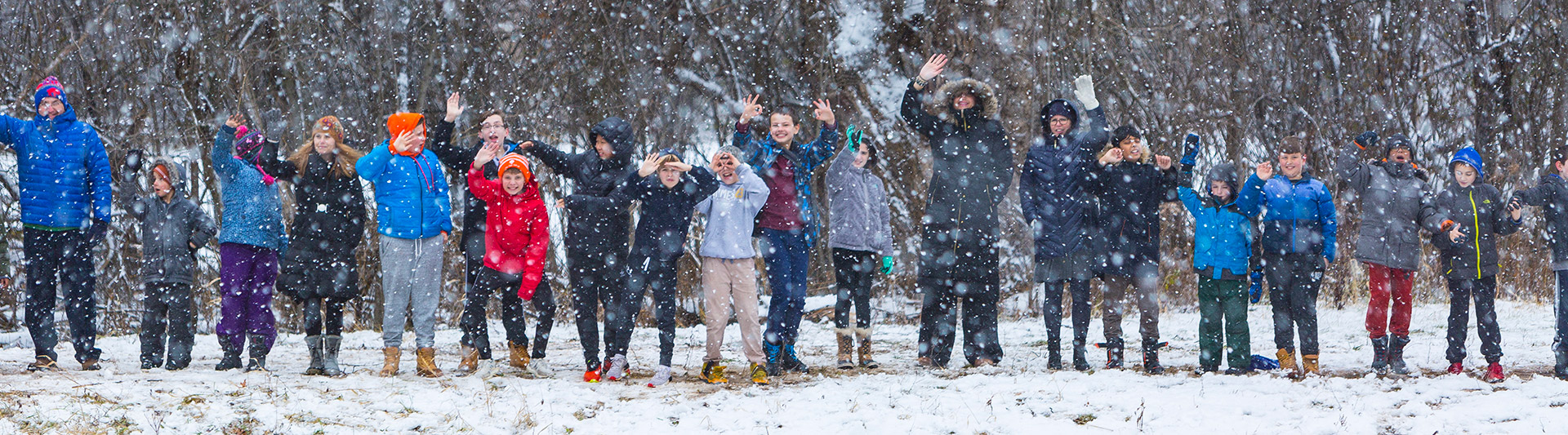 Students outside waving