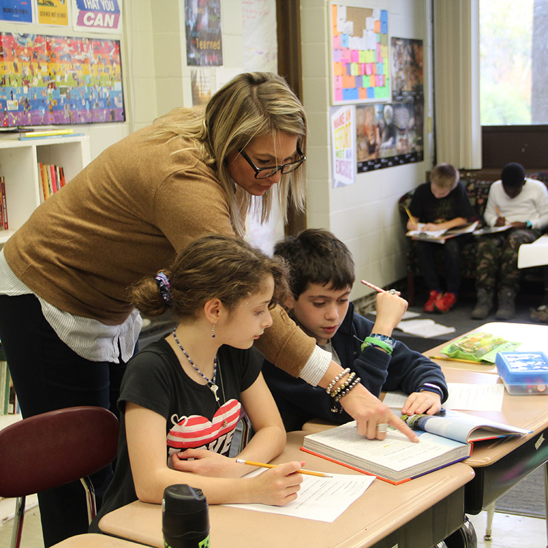 Teacher helping students